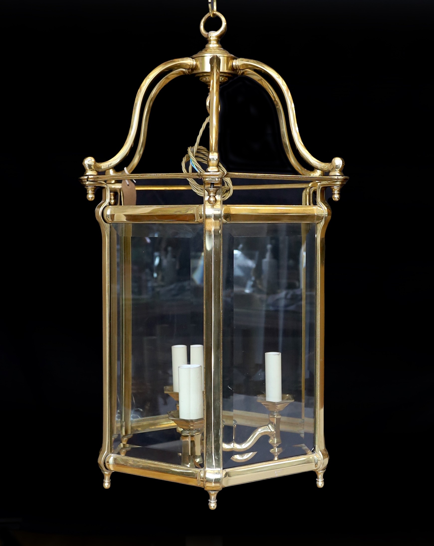 A large Georgian style hexagonal brass hall lantern with bevelled glass plates, height 79cm. width 48cm